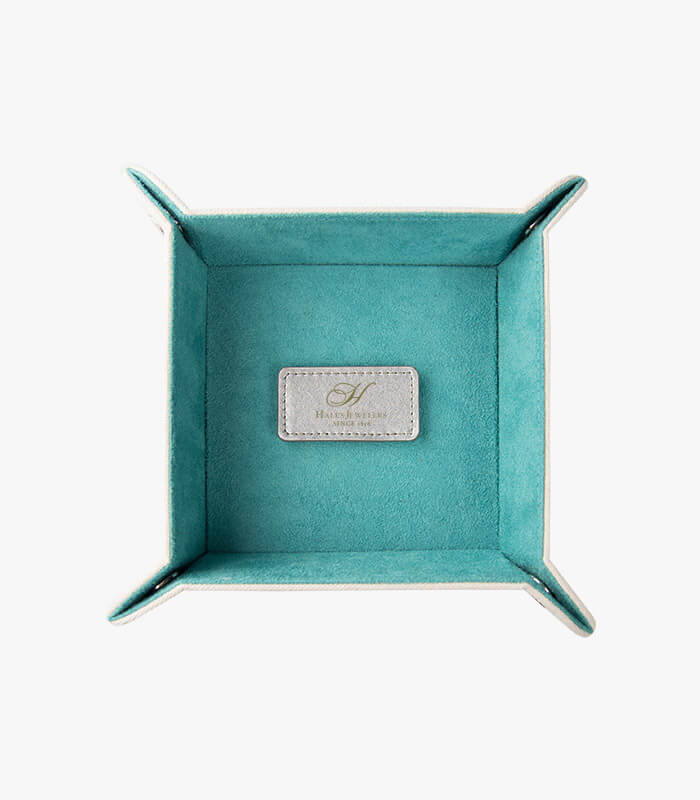 Lady's valet tray features a blue suede material with an engravable silver patch