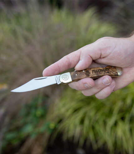 Open front of Nickelback burl knife engraved with logo